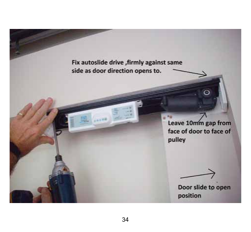 Autoslide drive unit mounted to the head track with pulley clearance gap